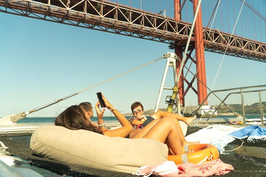 Lisbon: Catamaran Boat Party with Music, Open Bar & Dives - Starting at Doca de Santo Amaro, then easing onto the Tagus