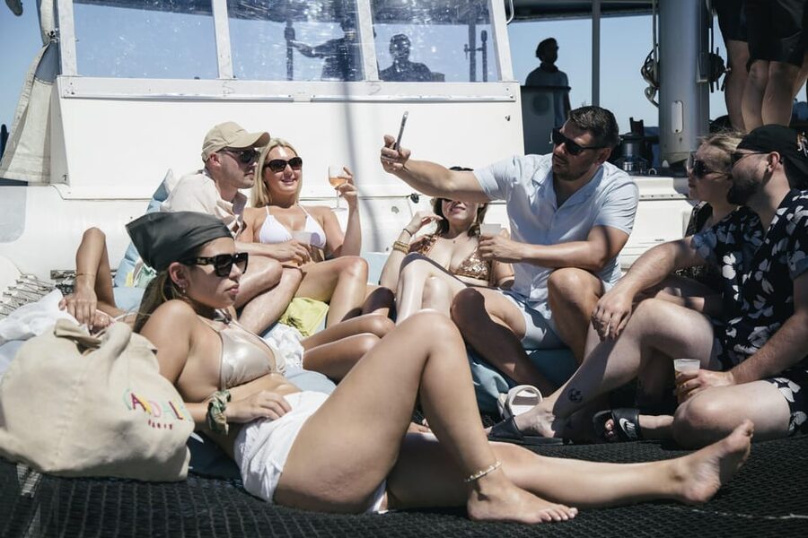 Lisbon: Catamaran Boat Party with Music, Open Bar & Dives - The 25 de Abril Bridge pass: the moment the cruise feels iconic