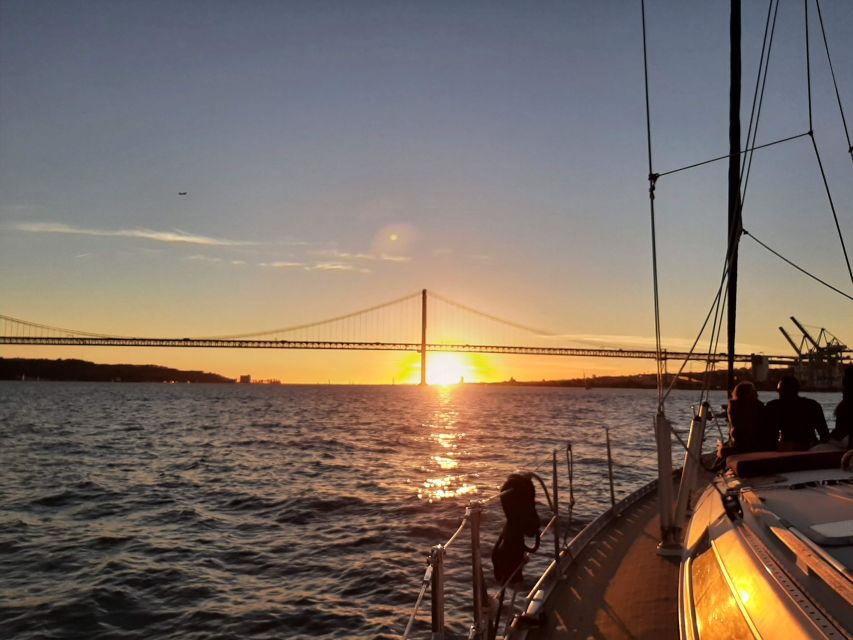 Lisbon: City Skyline Sailboat Cruise with Drink and Snacks - First moments: Santo Amaro Dock and the 25 de Abril Bridge shot