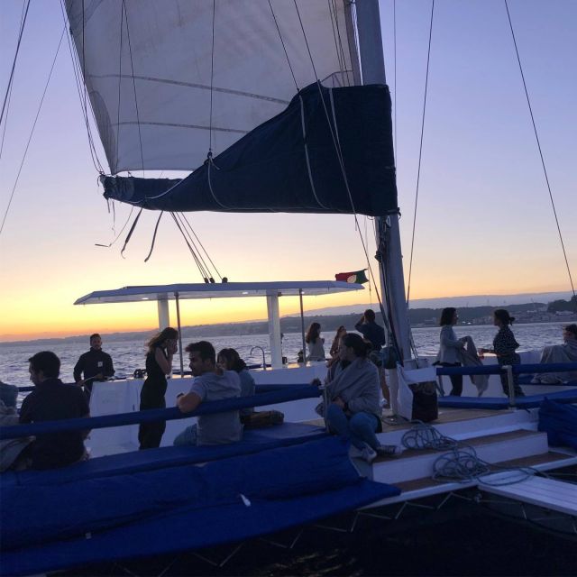 Lisbon: Private Catamaran Charter for up to 18-People - Under 25 de Abril Bridge to the Christ statue moment