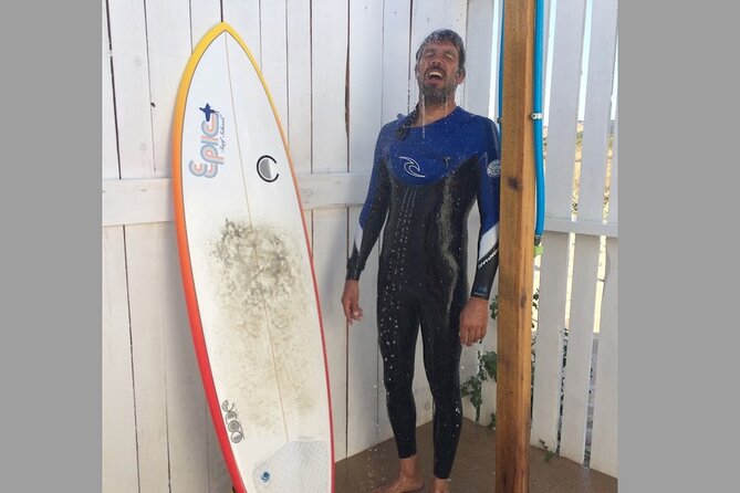 Priv Half Day Surf_full gear round & round trip transport_Lisbon - Beach base setup: locked cabin, private showers, and a food stop with ocean views
