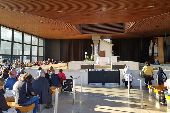 Private Small Groups Tour Fátima Full Day - Capela das Aparições: the chapel area, Mass, and candles that create a quiet rhythm