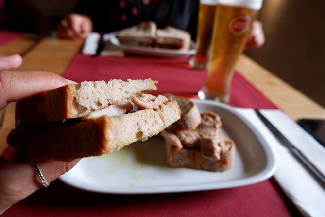 Winner 2025 Undiscovered Lisbon Food & Wine Tour by Eating Europe - Ginjinha Popular: fireman chorizo and a classic bifana welcome